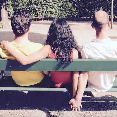 The picture shows three people in a polyamorous relationship.